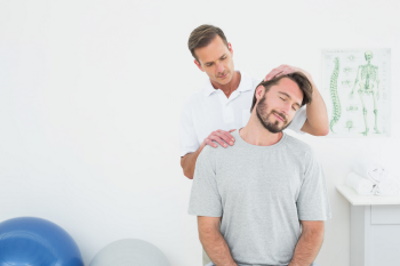A Chiropractor is preforming a neck adjustment on a patient. Vital Family Chiropractic - Chiropractic Treatment for Neck and Back Pain - Mt. Pleasant, SC.